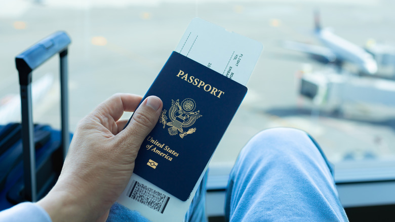 Traveler holding passport at the airport