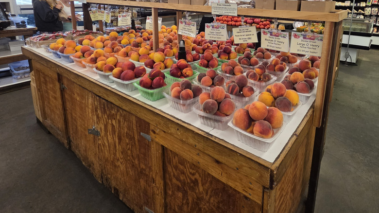 A display of fresh peaches for sale from the orchard at Ikeda's Country Market in Auburn, California