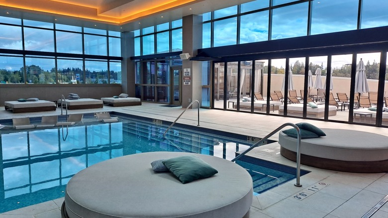 An indoor pool with cushioned seating around its edge at the Ilani Casino hotel