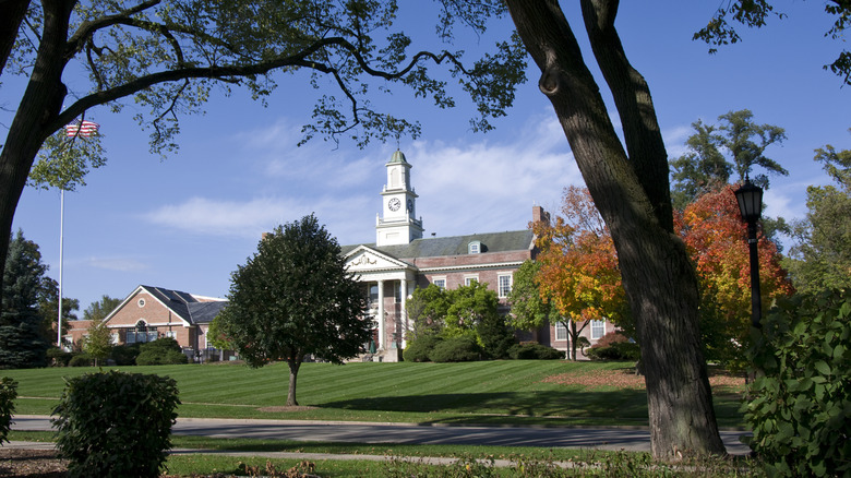 Historic hall with clock tower and grassy lawn in Hinsdale, Illinois.