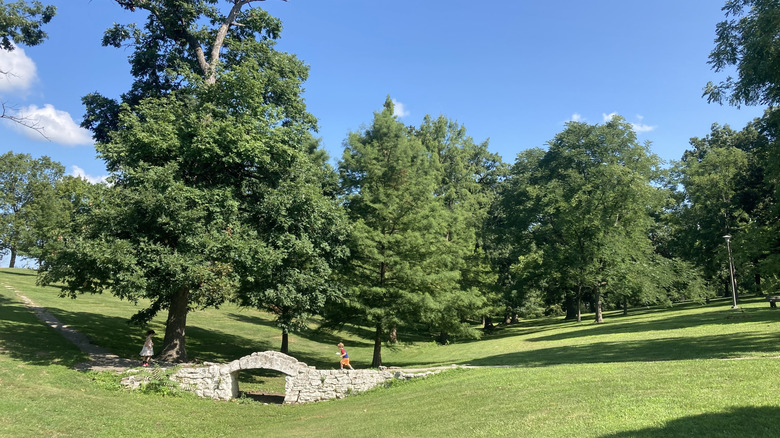 Children playing on a stone bridge in Duncan Park, Illinois