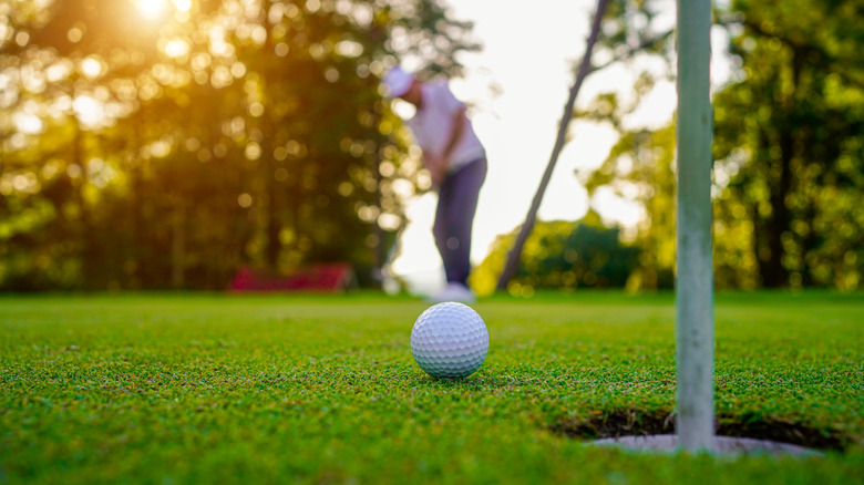 Golf ball with man in background