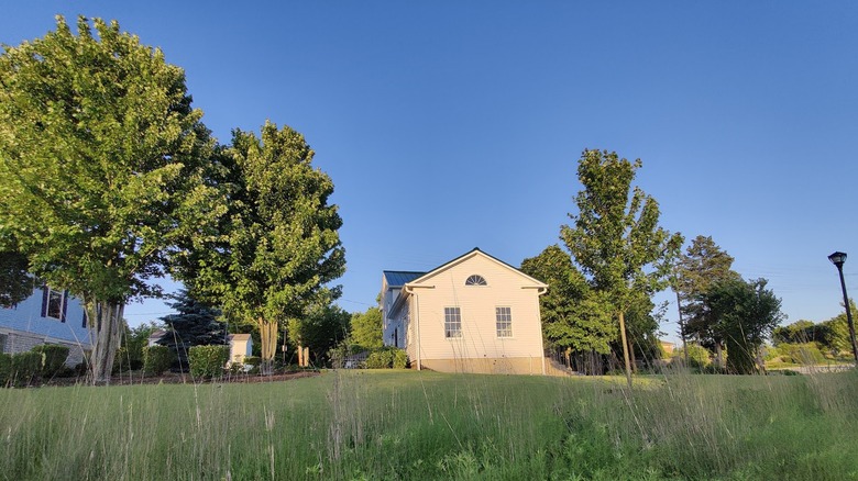 The Warrenville Historical Society building surrounded by a grassy field in Warrenville, Illinois
