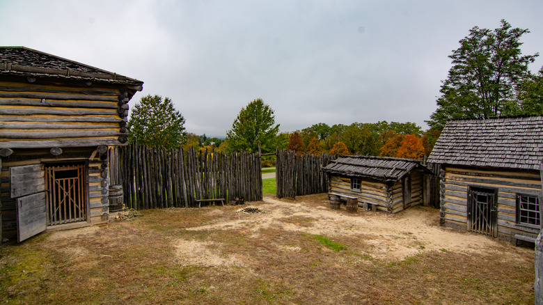 Wooden buildings surrounded by fall foliage at Apple River Fort State Historic Site