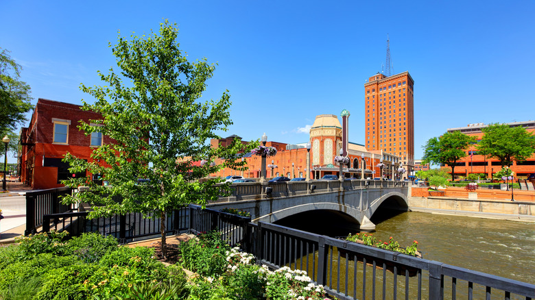 Red theater building visible from riverside bridge