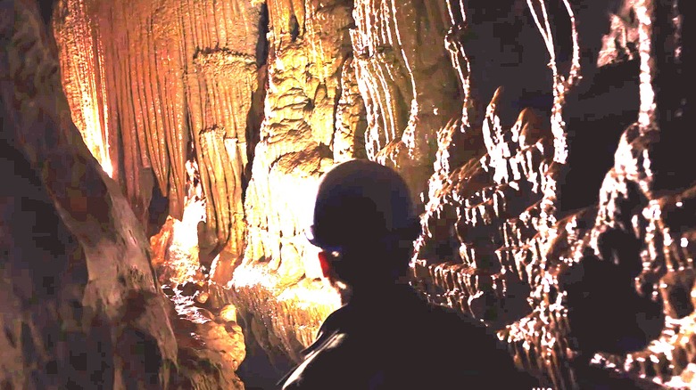 An explorer in a hard hat in Illinois Cavern