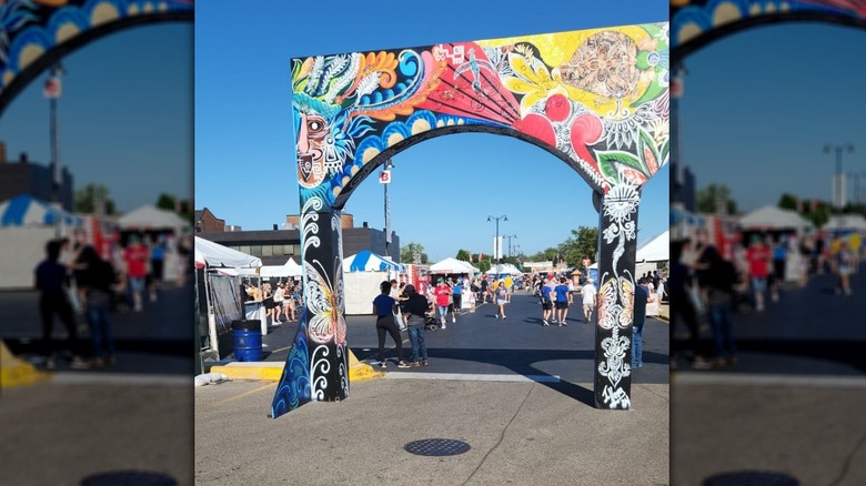 Painted archway leading into crowded Taste of Melrose Park festival outside of Chicago