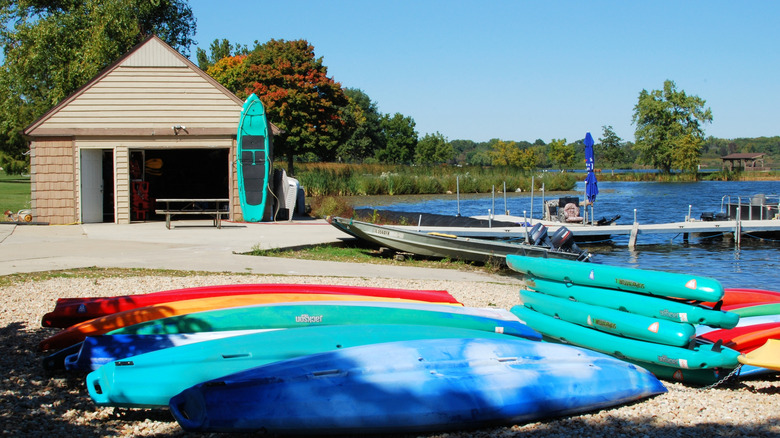 The boat house and a number of colorful kayaks lined up on shore at Shabbona Lake, Shabbona, Illinois