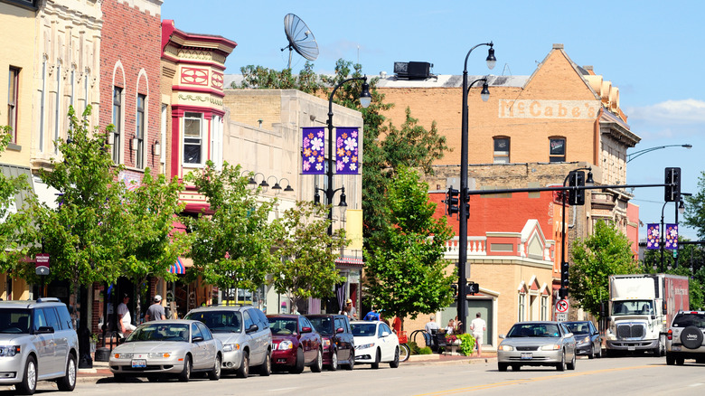 Cars move down a tree-lined street in downtown DeKalb.