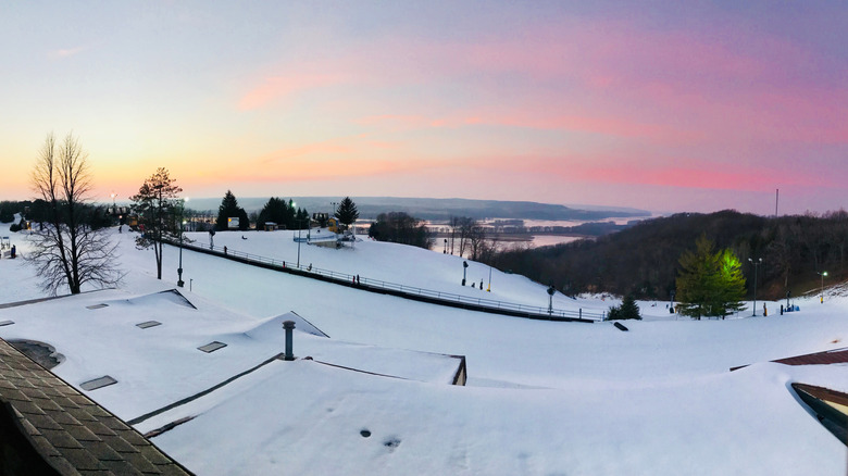 A view of a snow-covered hill during sunset at Chestnut with the Mississippi River in the background