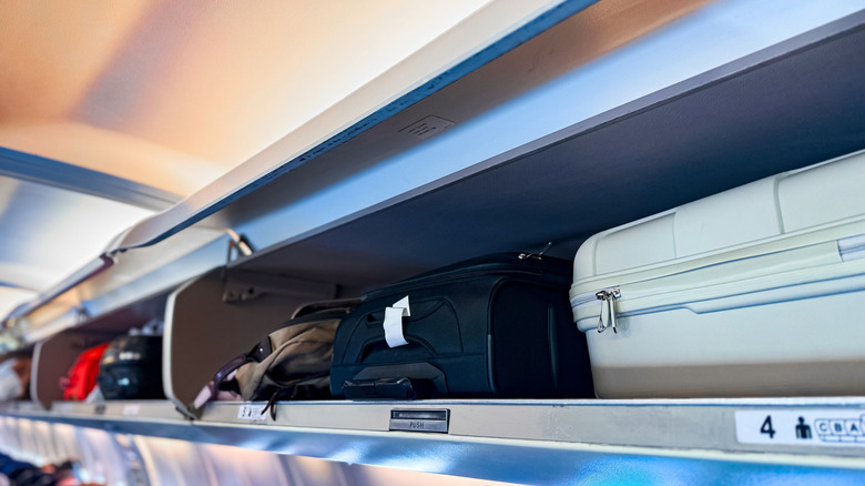 Open overhead compartments on a flight