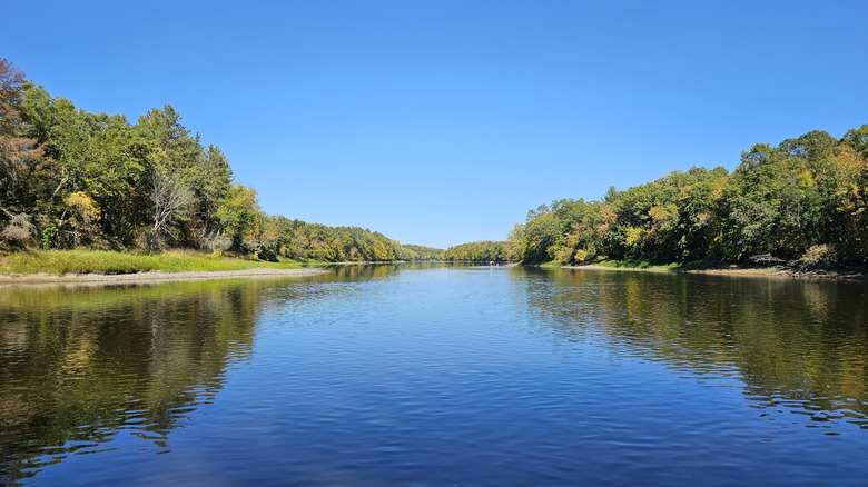 Wide and peaceful river lined by trees at Crow Wing State Park in Minnesota