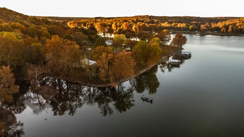 Man fishing from a boat during fall sunrise on Grand Lake in Oklahoma