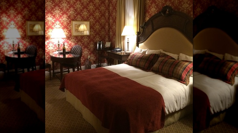 Bedroom in the Charley Creek Inn in Wabash with red wallpaper