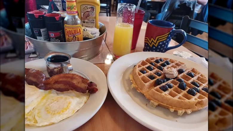 Plates of waffles, eggs, and bacon at Cafe Audrey at Fort Ben in Lawrence, Indiana