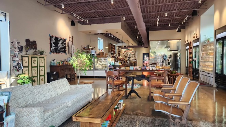Couch, coffee table, and seating inside Borage, with a counter in the background