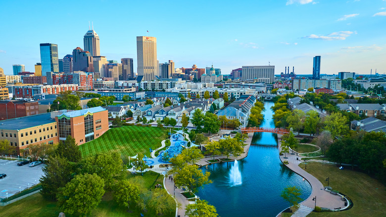 Aerial view of Indianapolis with buildings, greenery, and a lake