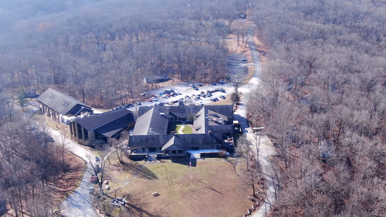 Aerial drone view of Abe Martin Lodge surrounded by forest.