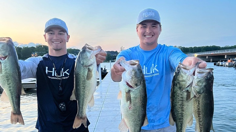 Two fisherman holding their winning largemouth bass catches