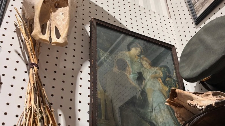 Old skulls, a painting and military hat hanging on a wall in Exit 76, Indiana