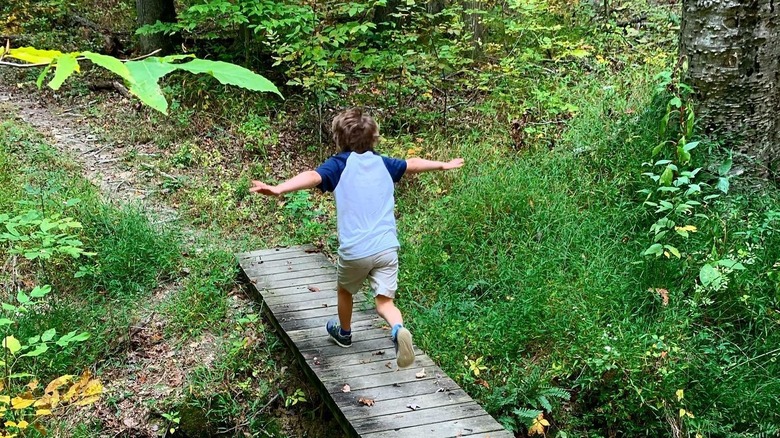 Kid walks on trail in Clark State Forest