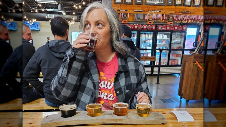 Woman enjoys flight of beer at Sunking Brewery