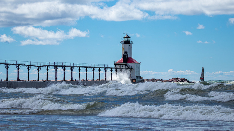 Michigan City Lighthouse on a summer day with high surf in Michigan City, Indiana USA