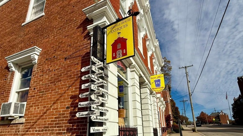 Red brick building Carriage House antiques painted sign blue sky Oldenburg