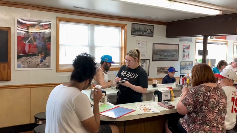 Customers ordering at the counter at Triple XXX Family Restaurant