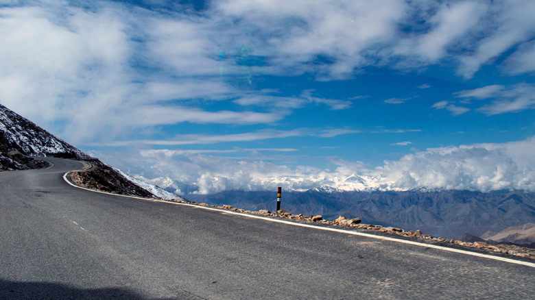 Winding road in Ladakh overlooking mountains.