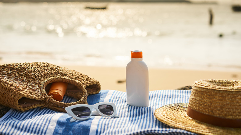 Beach gear laid out on towel