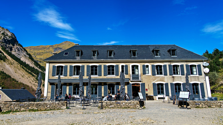 Village building in Gavarnie, France with mountain looming around it