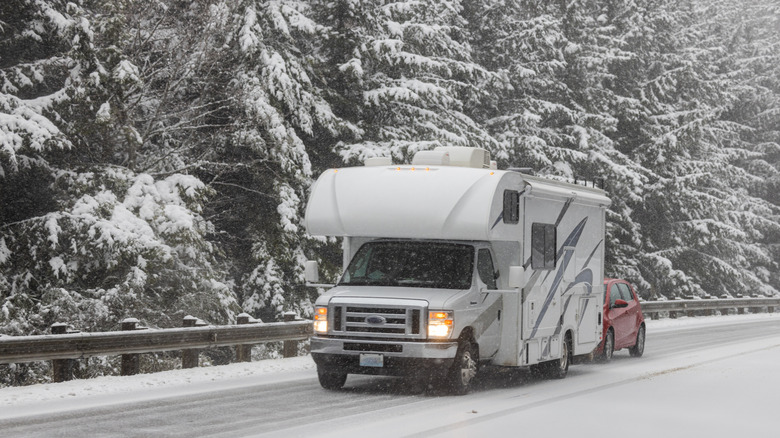 An RV driving along a snowy road