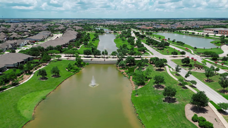 An aerial view of a suburb development along a waterway in Iowa Colony