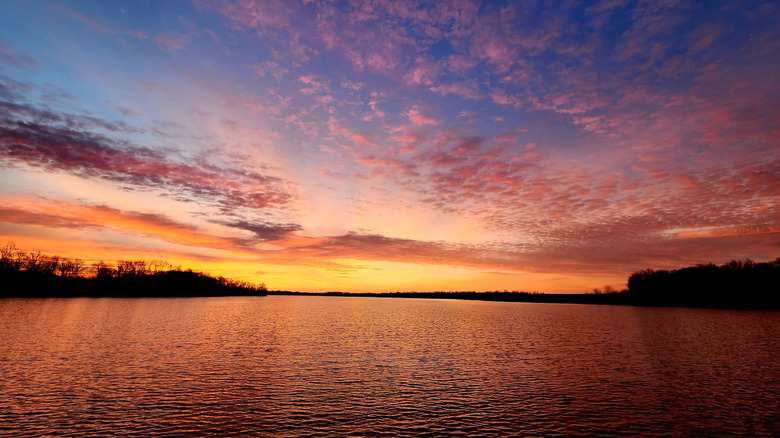A colorful pink and orange sunset at Big Creek Lake in Iowa