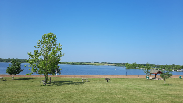 Lawn, trees, and a sandy beach at Big Creek State Park in Iowa