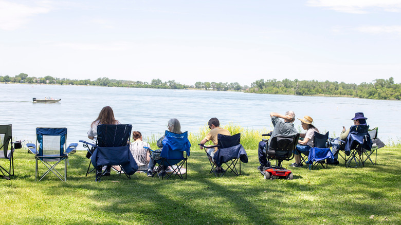 A group of people relaxing next to Lake Manawa