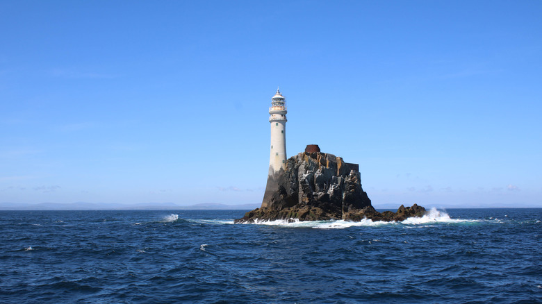 Fastnet lighthouse emerging from a rock in the middle of the ocean