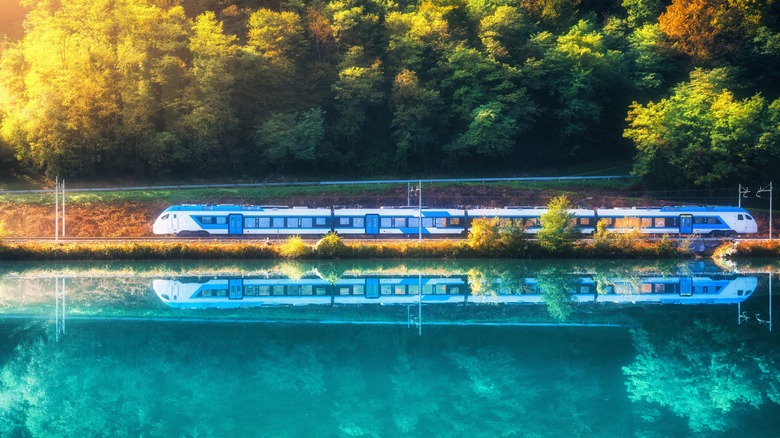 Train and reflection of train in blue lake