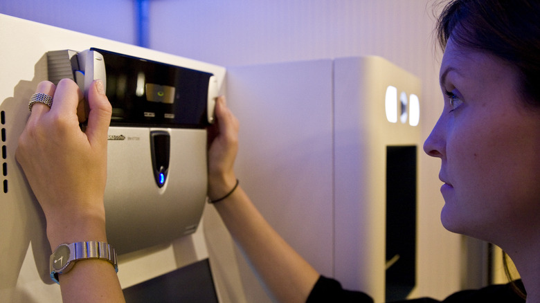 Woman getting scanned at a Clear kiosk