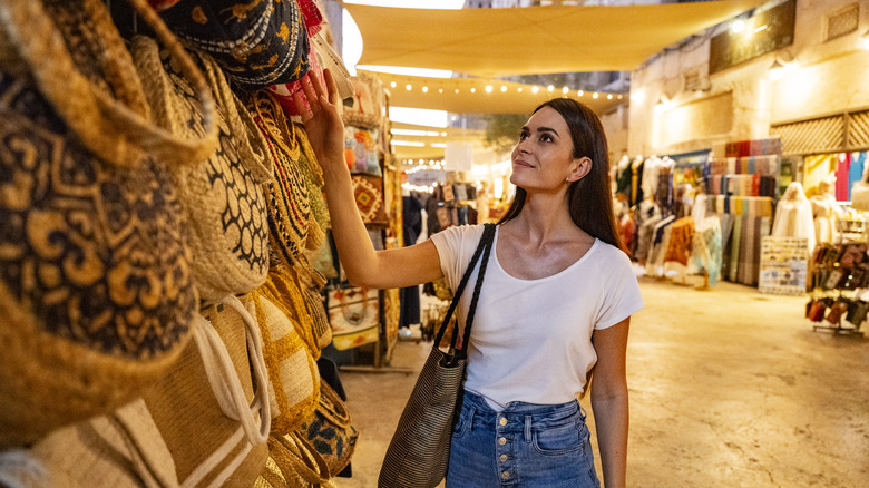 A woman browses for bags in a Dubai shopping mall