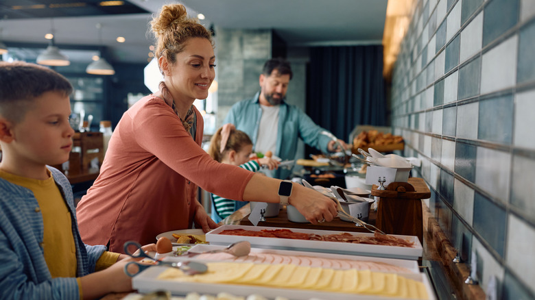 Family getting food at a hotel breakfast buffet