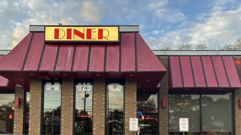 Exterior of Island Lake Diner with a sign and a red awning