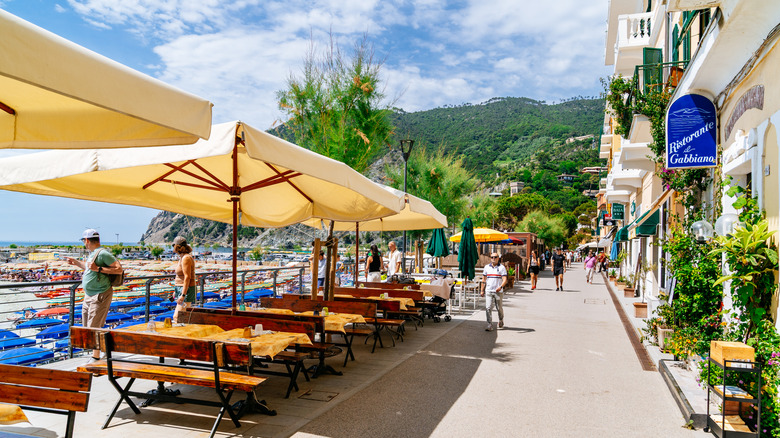 A spot along Passeggiata Lungomare in Monterosso al Mare with outdoor restaurant tables along the beach.