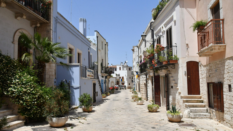 View of a street with blue and white buildings in Casamassima, Italy