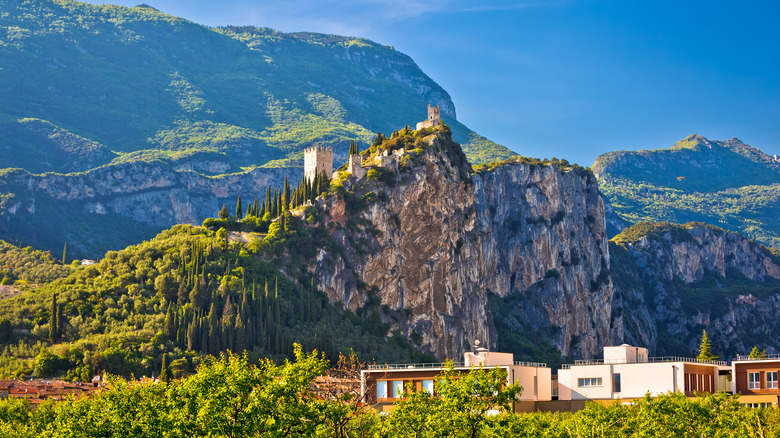 The Arco Castle rises on a bluff in the Alps