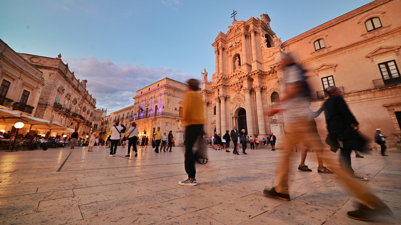 Tourists walking around the Piazza Duomo in Ortigia
