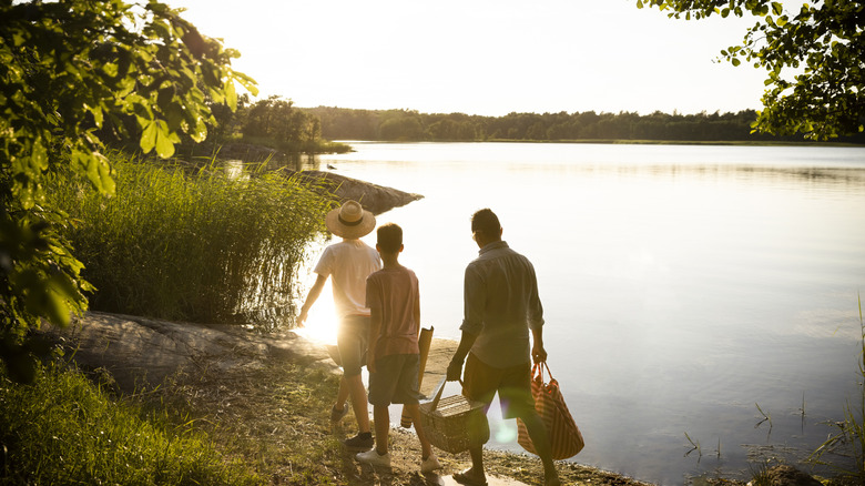 Family walking along a lake