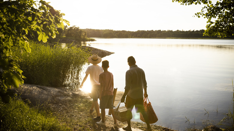 Family walking along a lake