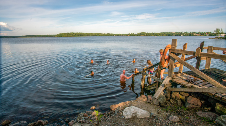 People swimming in a lake in Finland.